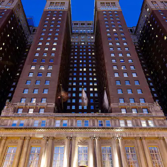 Three-point view of tall building with windows at night